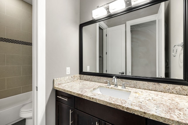 full bathroom with vanity, toilet, and tiled shower / bath