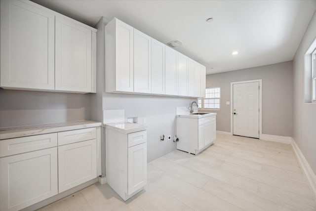 laundry area featuring hookup for a washing machine, cabinets, and sink