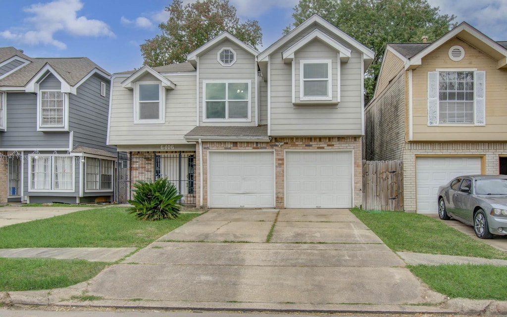 view of front of house featuring a front lawn and a garage