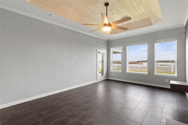 empty room with a raised ceiling, ceiling fan, wooden ceiling, and ornamental molding