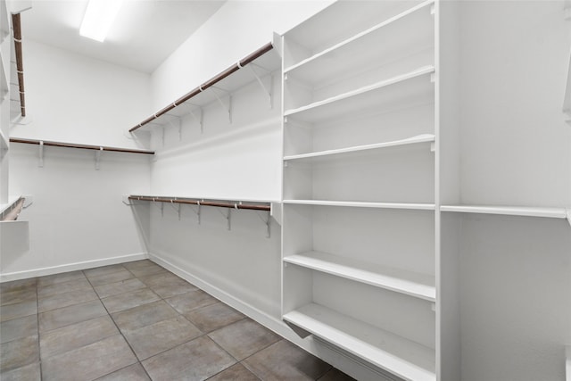 spacious closet featuring tile patterned flooring