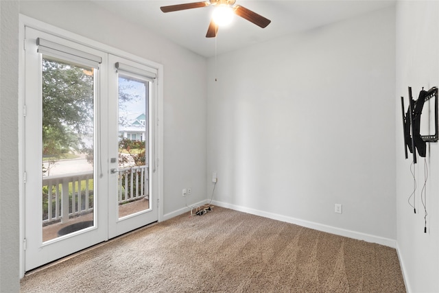 carpeted empty room with french doors and ceiling fan