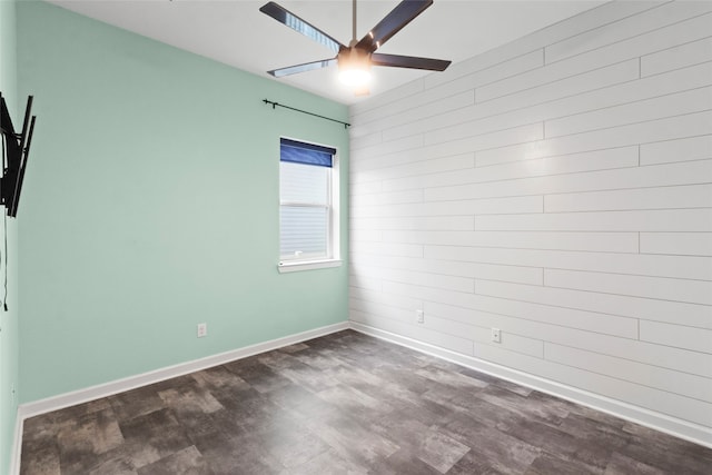 empty room featuring ceiling fan and dark wood-type flooring