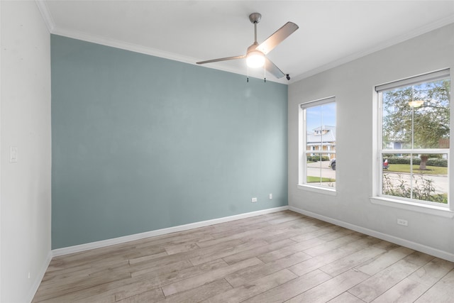 spare room featuring light hardwood / wood-style flooring, ceiling fan, and crown molding