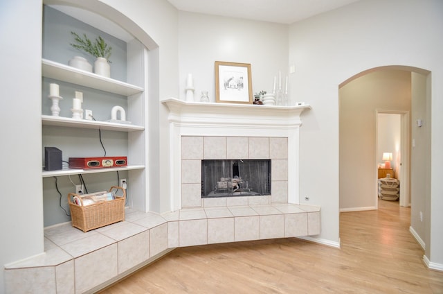 living room featuring hardwood / wood-style floors and a tile fireplace