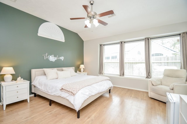 bedroom with ceiling fan, light hardwood / wood-style floors, and lofted ceiling