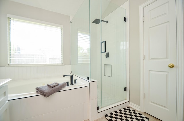 bathroom featuring separate shower and tub and a wealth of natural light