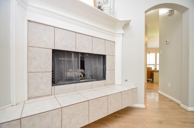 interior details featuring wood-type flooring and a fireplace