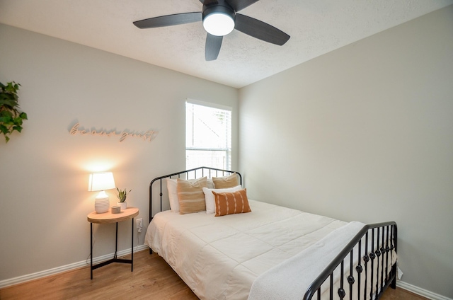 bedroom with hardwood / wood-style floors and ceiling fan