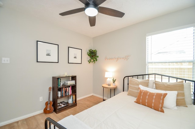 bedroom with ceiling fan and hardwood / wood-style flooring