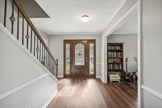 entrance foyer featuring a textured ceiling and dark hardwood / wood-style floors