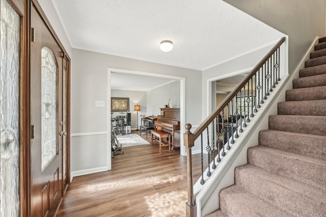 foyer featuring hardwood / wood-style floors and a textured ceiling