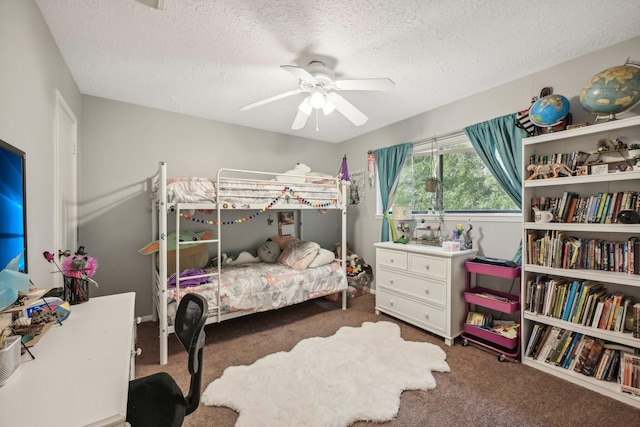 bedroom with a textured ceiling, dark carpet, and ceiling fan