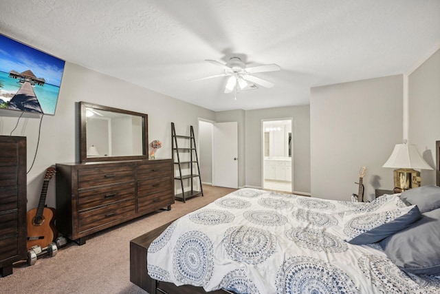 carpeted bedroom featuring a textured ceiling, ceiling fan, and ensuite bathroom