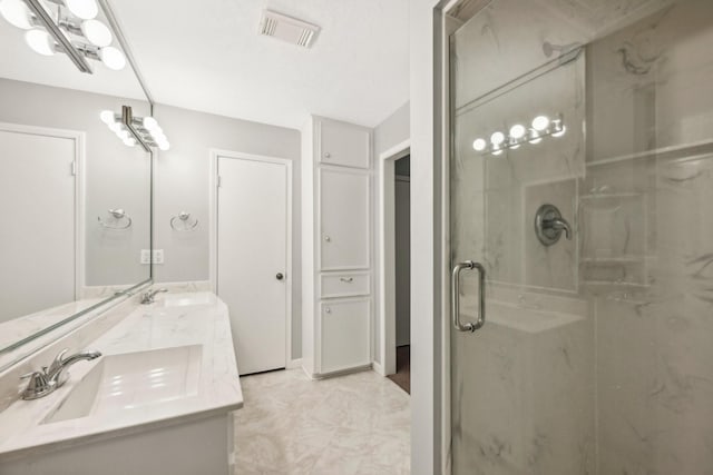 bathroom featuring vanity and an enclosed shower