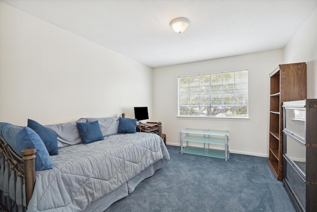 bedroom featuring dark carpet and baseboards