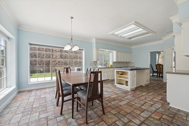 dining area with crown molding, brick floor, baseboards, and a notable chandelier