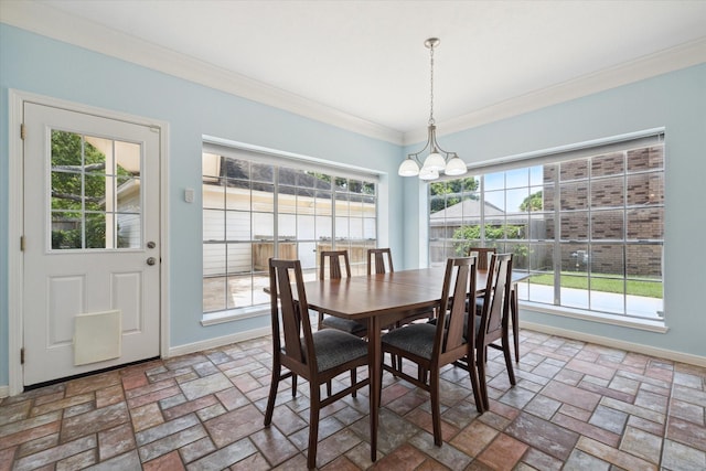 dining space with a notable chandelier, baseboards, stone tile floors, and crown molding