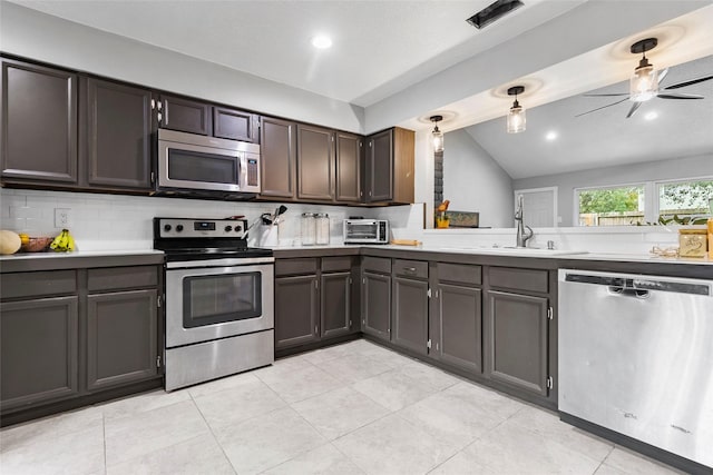 kitchen with ceiling fan, hanging light fixtures, backsplash, vaulted ceiling, and appliances with stainless steel finishes