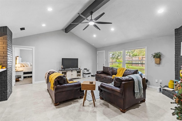 living room with lofted ceiling with beams, ceiling fan, a textured ceiling, and a brick fireplace