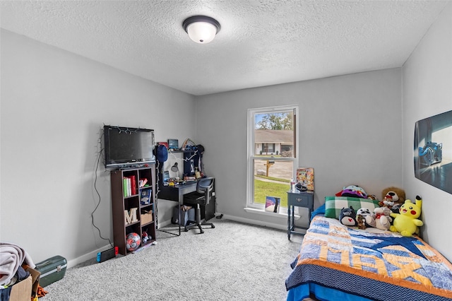 bedroom featuring carpet floors and a textured ceiling