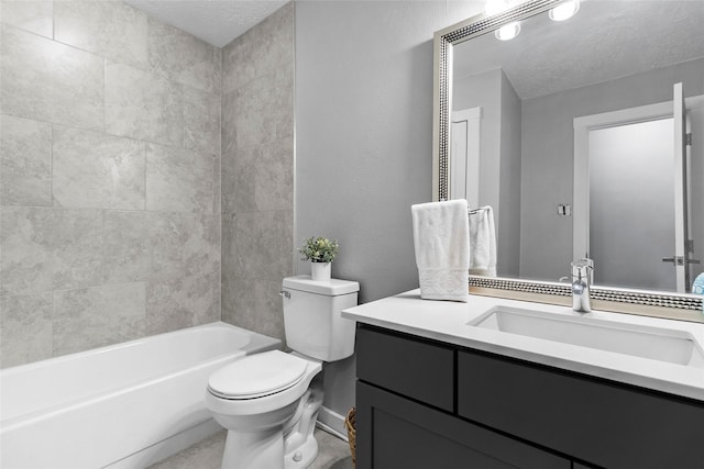 full bathroom with vanity, toilet, a textured ceiling, and tiled shower / bath combo