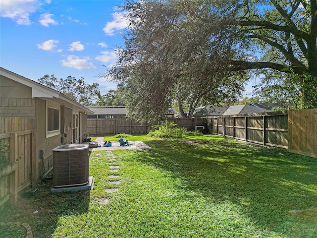 view of yard featuring a patio and central AC unit