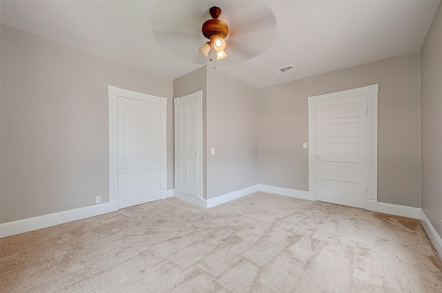 spare room with light carpet and ceiling fan