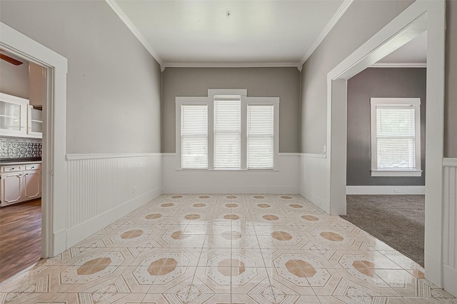 carpeted spare room with crown molding