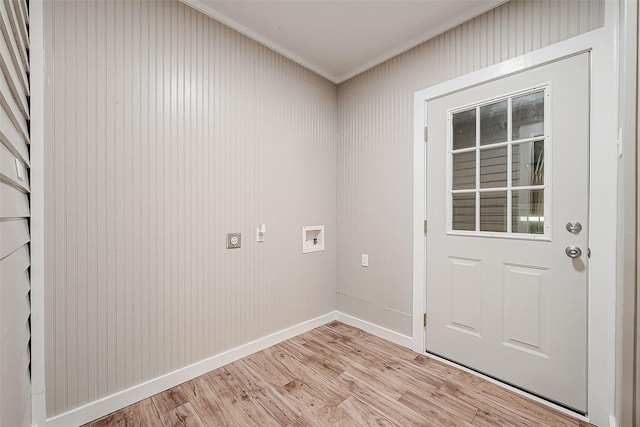 clothes washing area with electric dryer hookup, hookup for a washing machine, ornamental molding, and light wood-type flooring