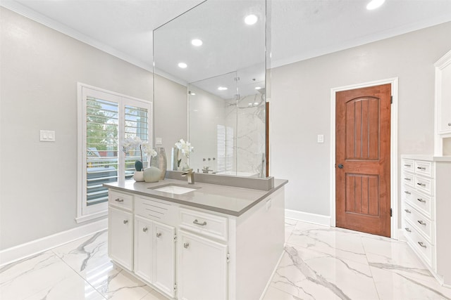 kitchen featuring ornamental molding, a textured ceiling, sink, a center island with sink, and white cabinets