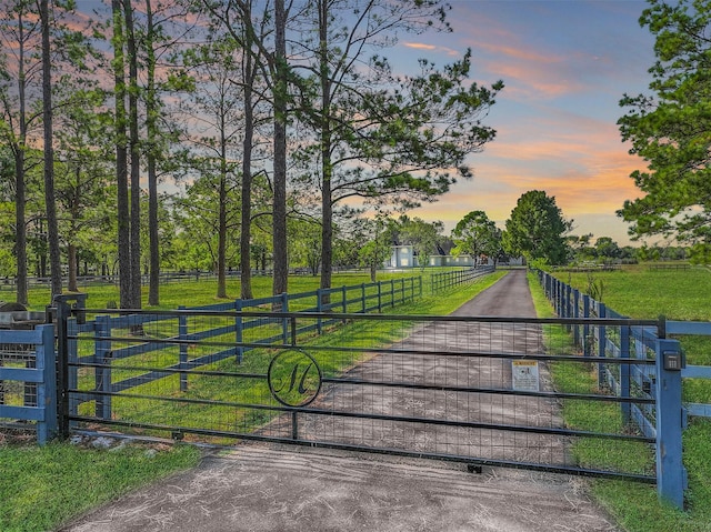 gate at dusk with a rural view