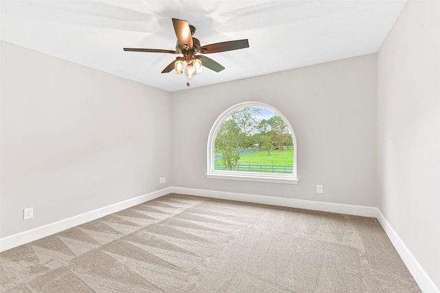 empty room with light carpet and ceiling fan