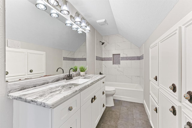 full bathroom featuring tiled shower / bath combo, a textured ceiling, vaulted ceiling, toilet, and vanity