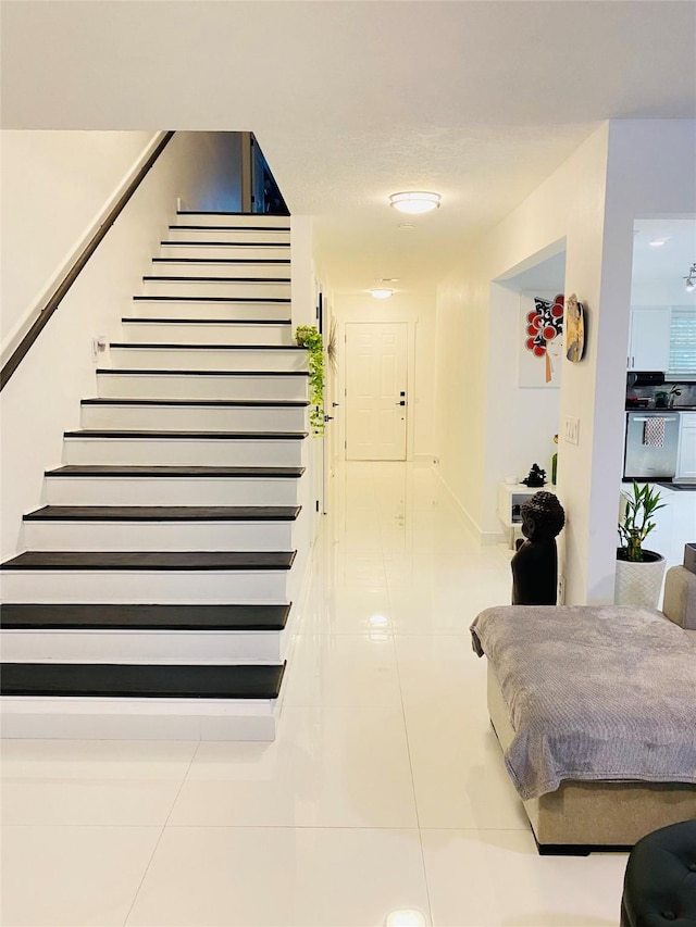 stairs featuring tile patterned flooring