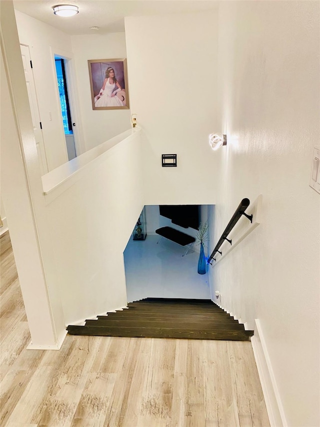 stairs with hardwood / wood-style floors