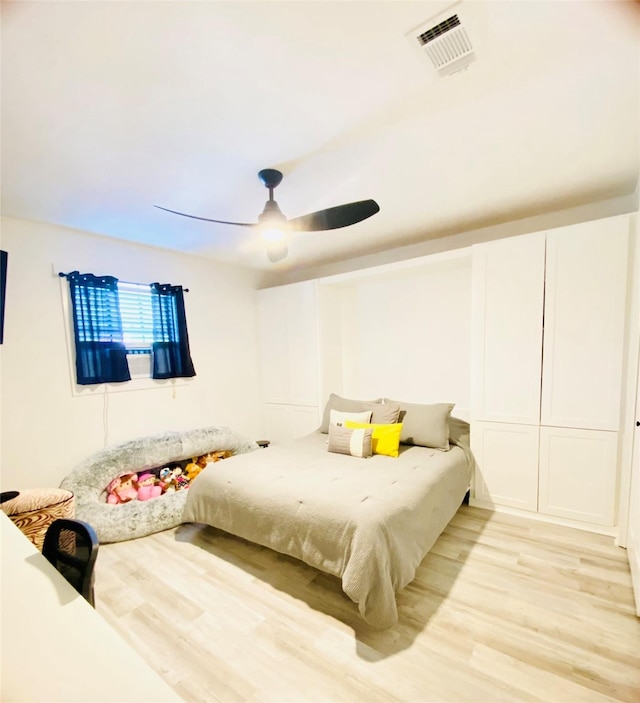 bedroom with ceiling fan and light wood-type flooring