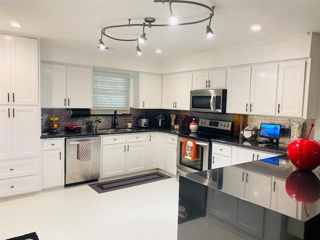 kitchen with backsplash, sink, white cabinets, and stainless steel appliances