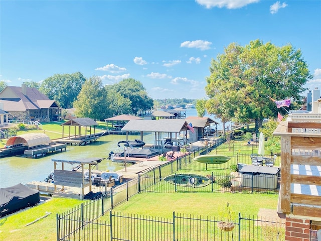 dock area with a lawn and a water view