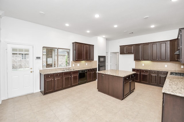 kitchen featuring backsplash, dark brown cabinetry, a kitchen island, and black appliances