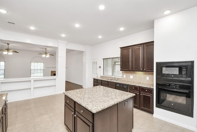 kitchen with sink, decorative columns, dark brown cabinets, a kitchen island, and black appliances