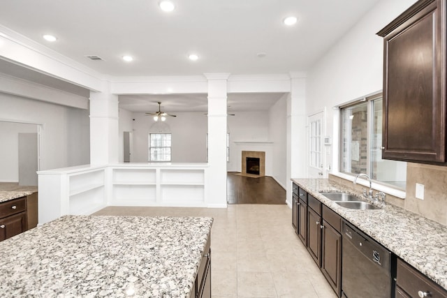 kitchen featuring light wood-type flooring, light stone counters, ceiling fan, sink, and dishwasher