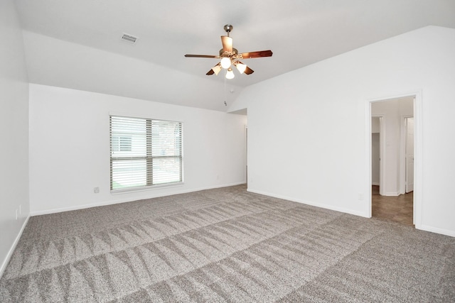 carpeted spare room featuring ceiling fan and lofted ceiling