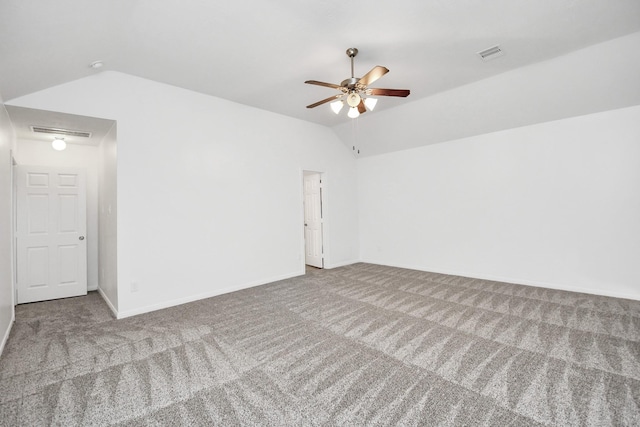 carpeted empty room with ceiling fan and vaulted ceiling