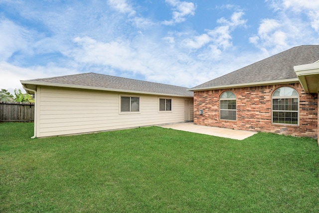 rear view of house with a yard and a patio area