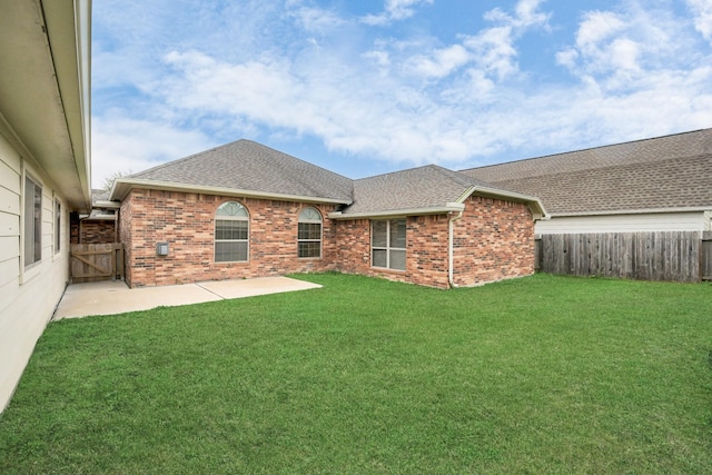 back of house featuring a patio area and a yard