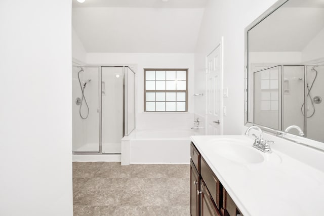 bathroom with vanity, shower with separate bathtub, and vaulted ceiling