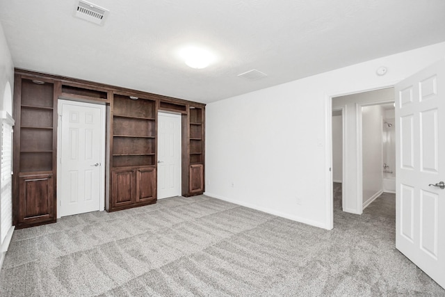 unfurnished bedroom with light colored carpet