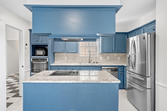 kitchen featuring blue cabinetry, sink, appliances with stainless steel finishes, and tasteful backsplash