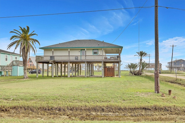 rear view of house with a carport and a lawn